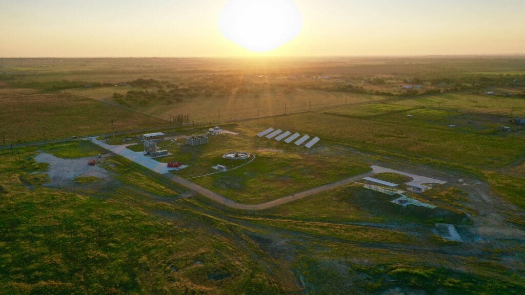 An aerial view of a solar farm at sunset.