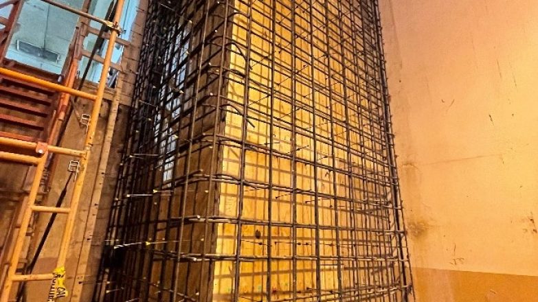 A large steel structure is being built in a building.