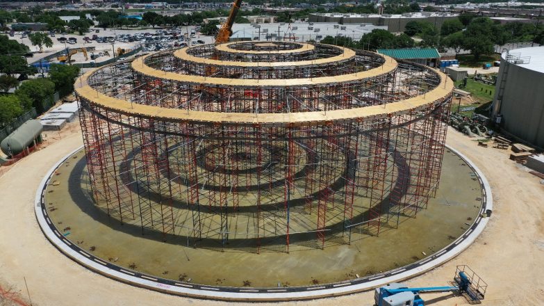 An aerial view of a circular structure under construction.