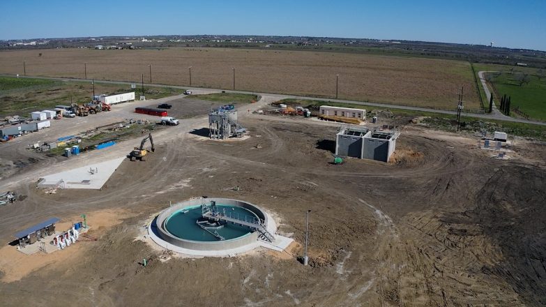 An aerial view of a construction site with a water treatment plant.