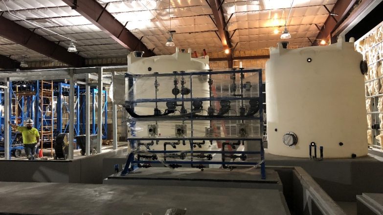 A large room with many tanks and pipes in it.