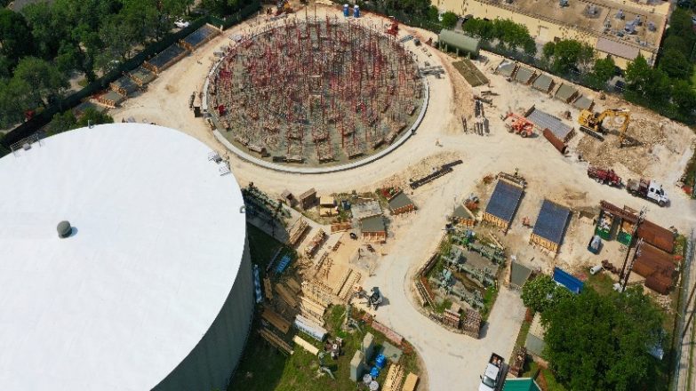 An aerial view of a construction site with a large water tank.