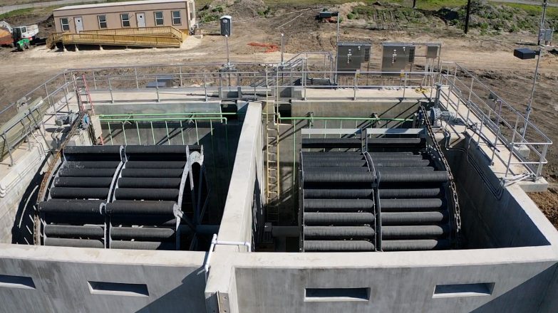 An aerial view of a construction site with a large concrete structure.