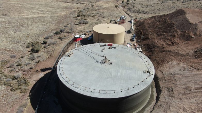 An aerial view of a large water tank in the desert.