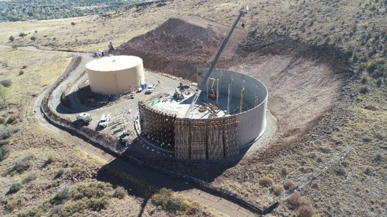 An aerial view of a construction site with a large tank.