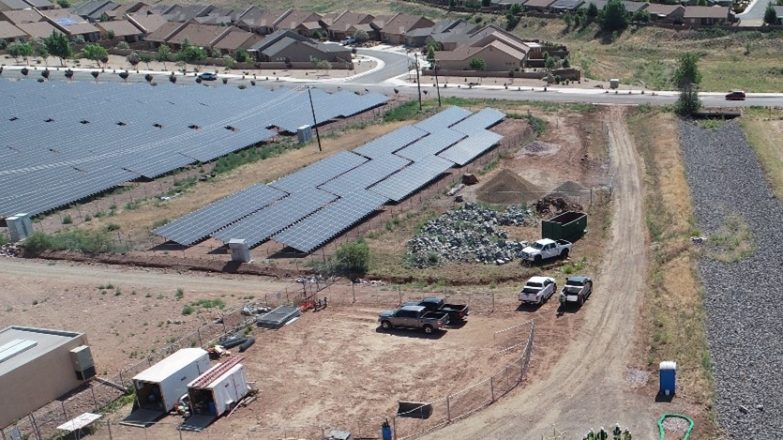 An aerial view of a solar farm in a rural area.