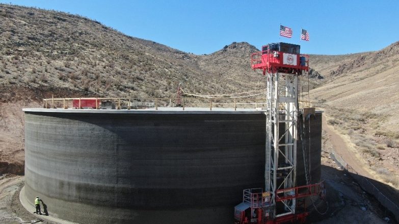 A large cement tank is being built in the desert.